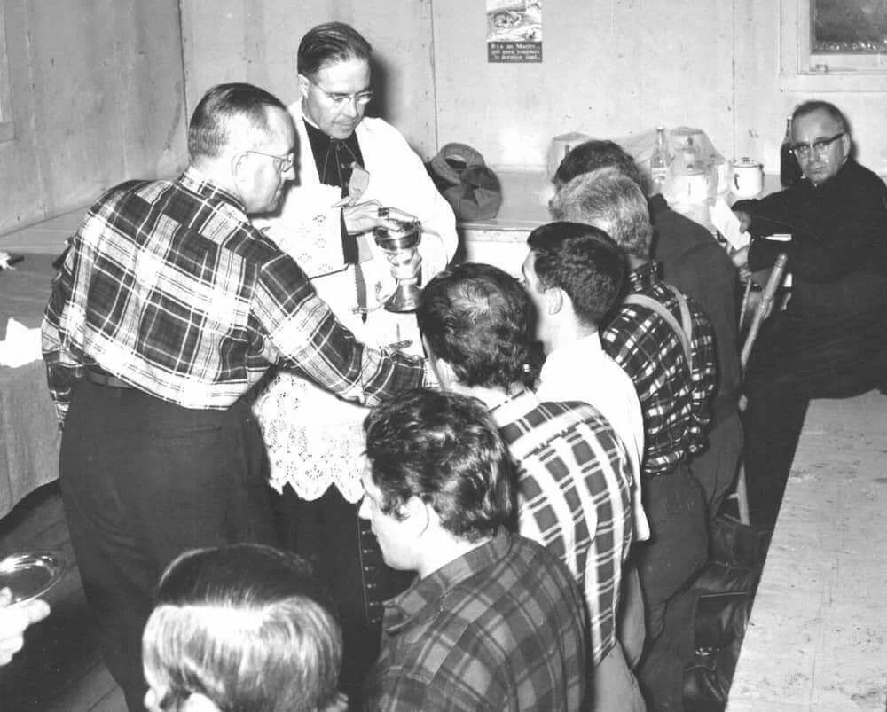 Bishop Couturier celebrates Mass for the workers gathered in the hall