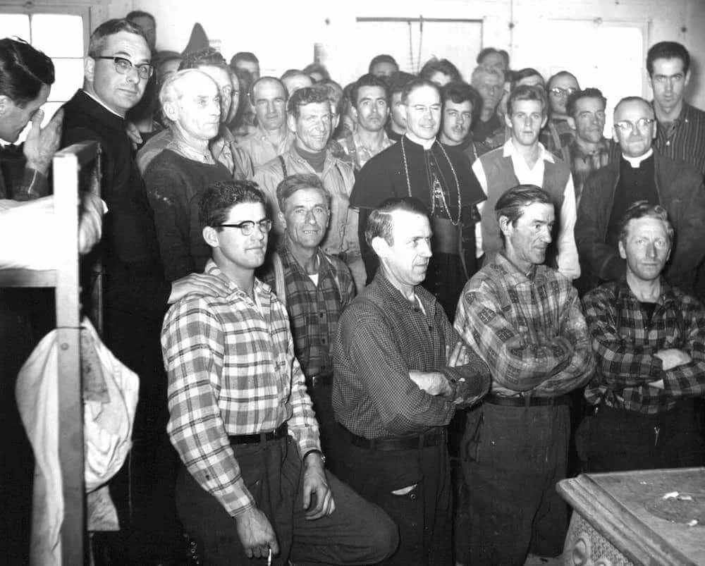 Bishop Couturier, Father Beauchemin, and the workers gathered for a photograph